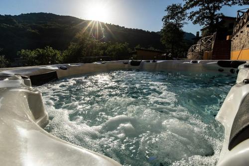a hot tub with the sun in the background at Villa Lara in Tortorici