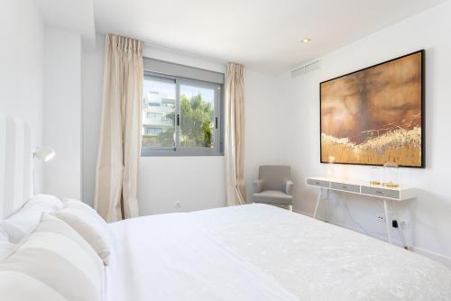 Un dormitorio blanco con una cama blanca y una ventana en Janssun Cabopino Luxury Apartment by GHR Rentals, en Marbella