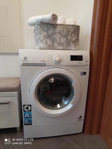 a washing machine with a towel on top of it at Apartments Drpic in Gabonjin