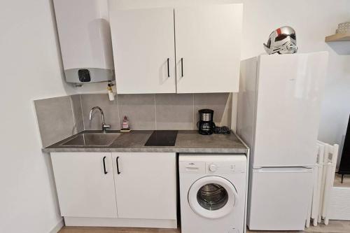 a kitchen with white cabinets and a washing machine at GregBnb-com - Centre Ancien - T2 Street Art - Wifi in Toulon