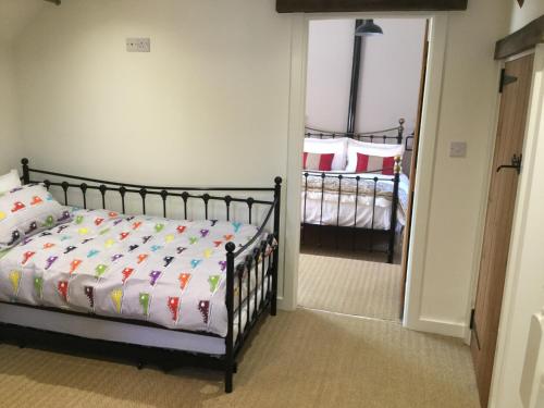 a bedroom with a bed and a door leading into a room at Impeccable cottage suitable for Three adults in Tockwith