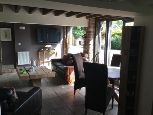 a living room with a couch and a table at Impeccable cottage suitable for Three adults in Tockwith