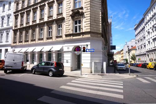 a car parked in front of a building on a street at Room 55 in Vienna