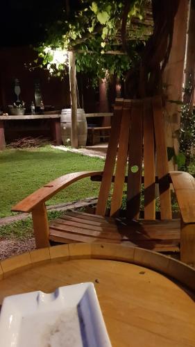 a wooden bench sitting next to a table at Posada Borravino in Chacras de Coria