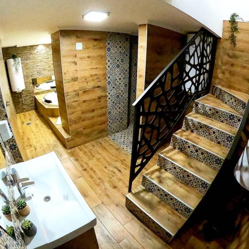a bathroom with a staircase and a sink and a bathroom at Canti apartments in Novi Sad
