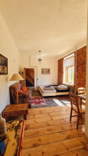 a living room with a couch and a table at Butterfly House in Pāvilosta