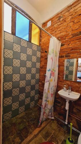 a bathroom with a sink and a shower at Butterfly House in Pāvilosta