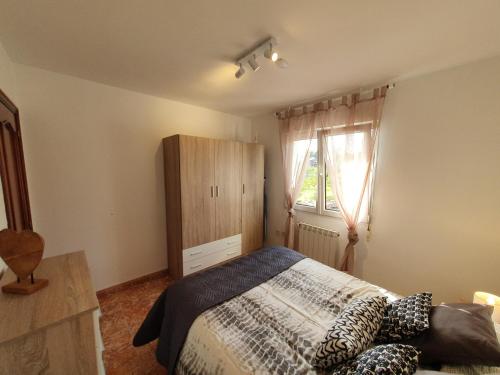 a bedroom with a bed and a dresser and a window at Villa Lola - Casa con Futbolín-Billar-Diana - 6pax - VV-1734-AS in Gijón