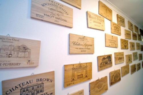 a wall with wooden signs on a wall at Hotel Dalberg in Sankt Martin