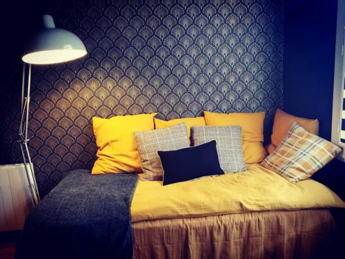 a bed with many pillows on it in a room at Aix-en-Provence : le boudoir du centre historique in Aix-en-Provence