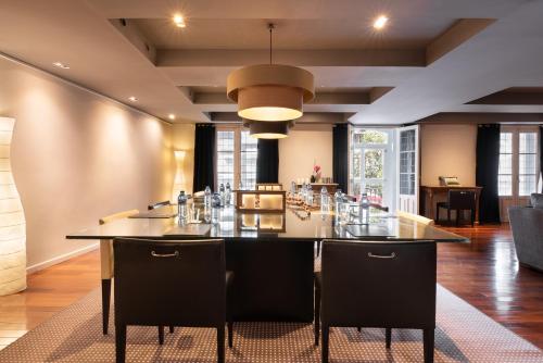 a dining room with a large table and chairs at Eurostars Marqués de Vallejo in Logroño