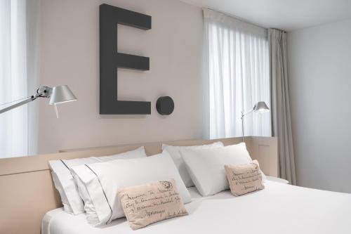 a bedroom with a bed with white sheets and pillows at Eurostars Marqués de Vallejo in Logroño