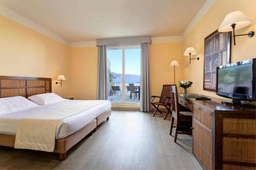 Un ou plusieurs lits dans un hébergement de l'établissement Hotel Punta San Martino