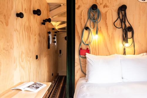 a bedroom with a bed with a headboard with headphones on it at SWEETS - Omvalbrug in Amsterdam