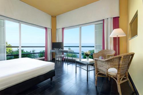 a bedroom with a bed and a table and chairs at Punta San Martino in Arenzano