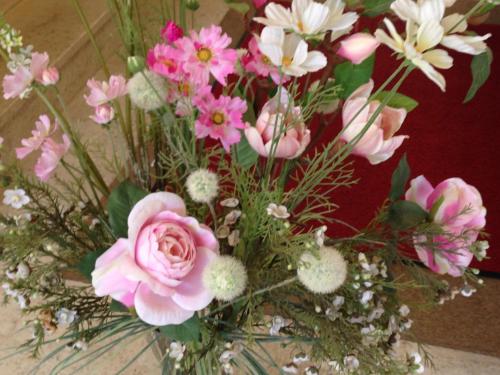 a vase filled with pink and white flowers at Hôtel de La Poste in Douvaine