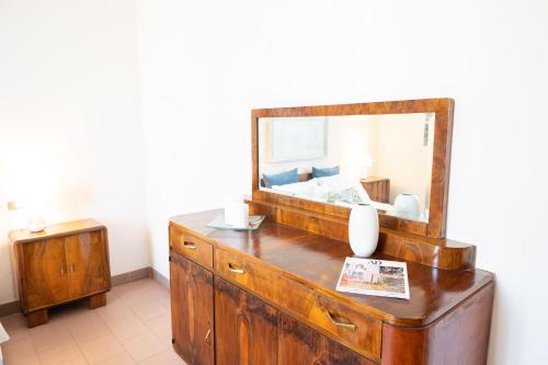 a bathroom with a dresser with a mirror on it at L'angolo di Gioia in Montecarlo