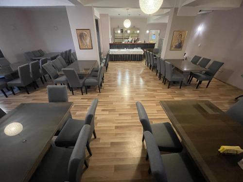a restaurant with tables and chairs and a bar at Hotel Frankoni in Međugorje