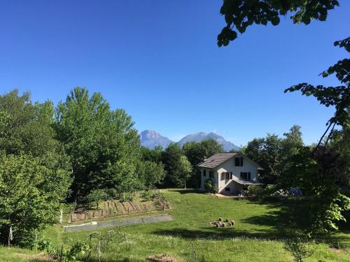 a house in the middle of a field with trees at Casa Betulla in Valmorel