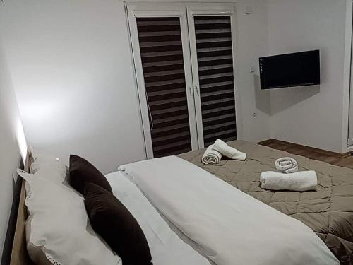 a bedroom with a bed with two towels on it at Dany Apartments in Gevgelija