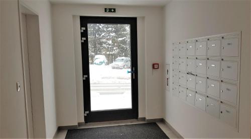 a door in a room with lockers and a window at Residence Kotel in Rokytnice nad Jizerou