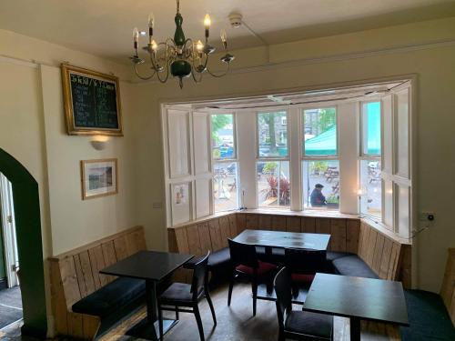 a dining room with two tables and a window at The Heights Bunkhouse in Llanberis