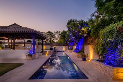 a swimming pool in a backyard with a gazebo at Frank Porter - The Villa, Ponderosa in Dubai