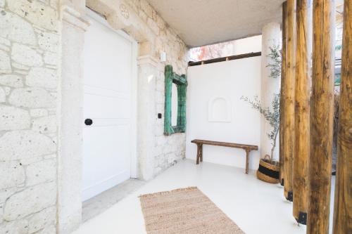 a hallway with a door and a bench at ZOE ALAÇATI in Alacati