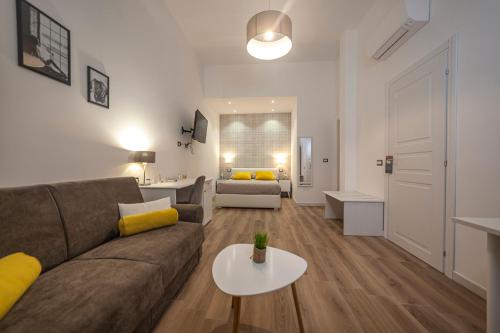 a living room with a couch and a table at Palazzo Lombardi Al Vicolo in Sassari