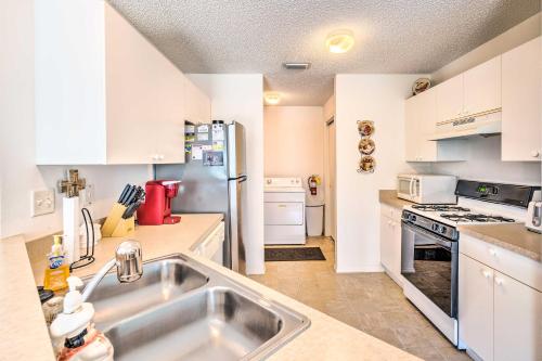 a kitchen with a sink and a refrigerator at Sunny Home in The Villages with Lanai and Pool Access! in The Villages