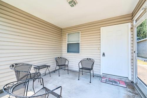a patio with four chairs and a white door at Sunny Home in The Villages with Lanai and Pool Access! in The Villages