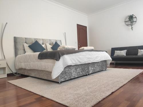 a bedroom with a large bed and a rug at Enchanted Villa in Tavira