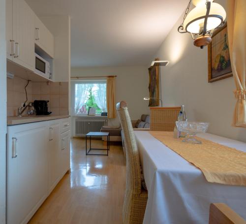 a kitchen and dining room with a table and chairs at Gästehaus Casa Cristina in Bad Krozingen