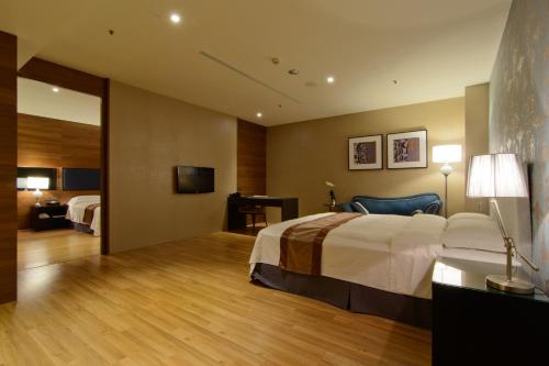 a hotel room with a bed and a television at Grand Crystal Hotel in Hsinchu City