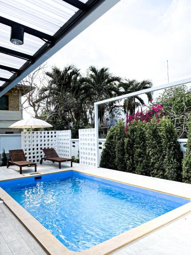 a swimming pool on the patio of a house at Ban Rub Lom Pool Villa 3 difference villas in Rayong