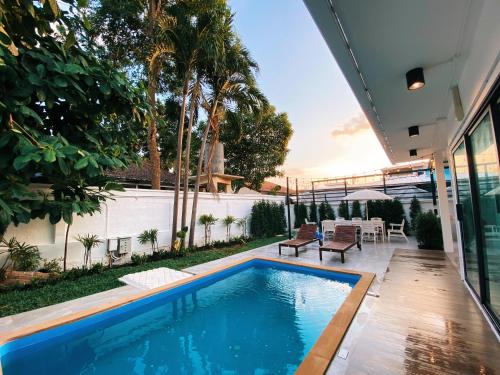 a swimming pool in the backyard of a house at Ban Rub Lom Pool Villa 3 difference villas in Rayong