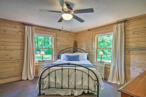 a bedroom with a bed and a ceiling fan at Lakefront Waterloo Cabin with Dock, Kayaks and Grill! in Waterloo