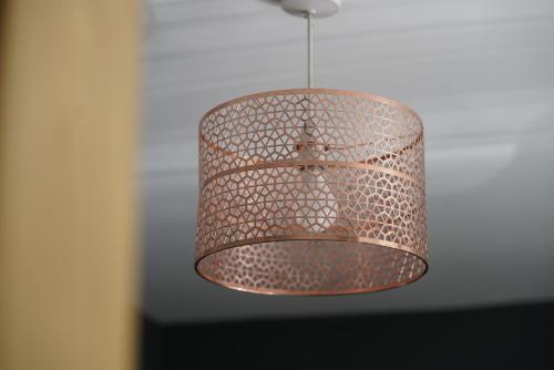 a metal lamp hanging from a ceiling at Risca Retreat in Risca