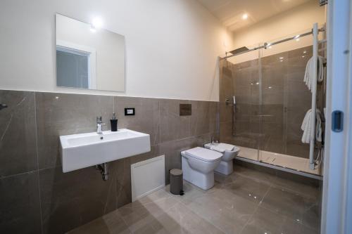 a bathroom with a sink and a toilet and a shower at Amaris in Palermo