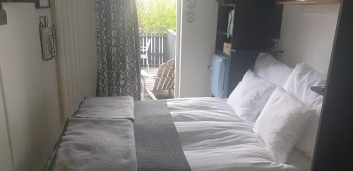 a bed sitting in a room with a window at Hotell Hanöbris på Kivik in Kivik