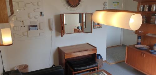 a living room with a chair and a mirror at Hotell Hanöbris på Kivik in Kivik