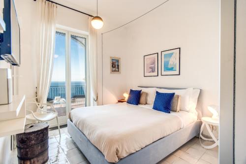 une chambre avec un lit et une vue sur l'océan dans l'établissement VILLAPOSITANO Tre Archi, à Positano