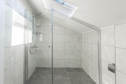 a shower with a glass door in a bathroom at La Moda Aparts in Kaş