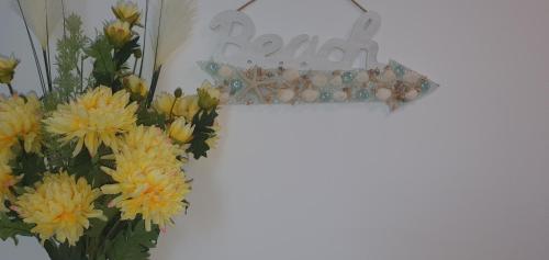 a cross with flowers and a sign that readsoria at Ema in Vama Veche