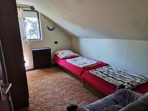 a small room with two beds in a attic at Aradi Apartman Siófok in Siófok