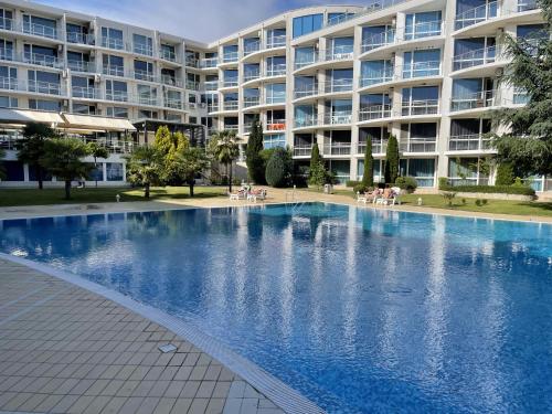 a large swimming pool in front of a large apartment building at Day Dream in Burgas City
