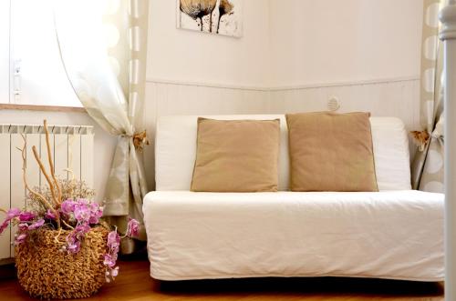 a white bed with two pillows in a bedroom at RE UMBERTO b&b - Suite di charme e Country rooms in San Salvo