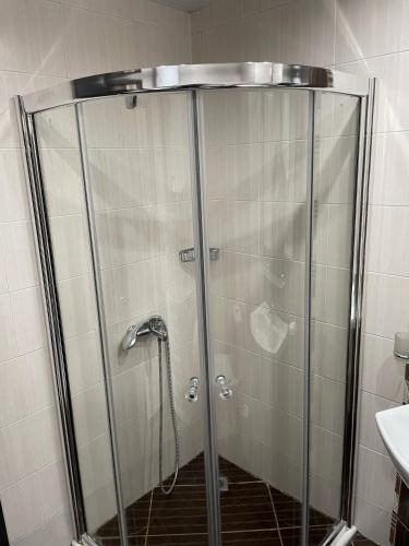 a shower with a glass door in a bathroom at Day Dream in Burgas