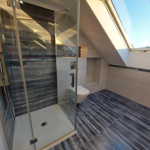 a bathroom with a shower and a toilet at Slow life nad jeziorem in Łukta