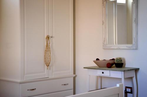 a bedroom with a white cabinet and a mirror at RE UMBERTO b&b - Suite di charme e Country rooms in San Salvo